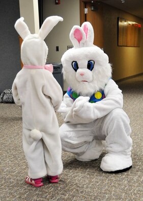 A child dressed as the Easter Bunny meets the Easter Bunny during the Easter eggstravaganza party held for the children of Montana Air National Guard members at the 120th Airlift Wing in Great Falls, Mont., March 23, 2016. (U.S. Air National Guard photo by Senior Master Sgt. Eric Peterson)