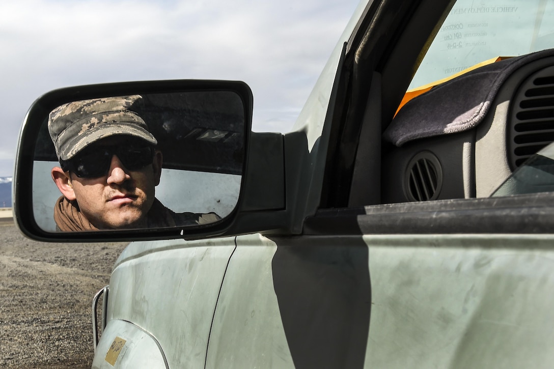 Air Force Senior Airman Christopher Traphagan looks in his rear view mirror while backin in a truck during Exercise Turbo Distribution 16-02 at Amedee Army Airfield, Calif., March 15, 2016. Traphagan is assigned to the 821st Contingency Response Squadron Aerial Port Flight. Air Force photo by Staff Sgt. Robert Hicks
