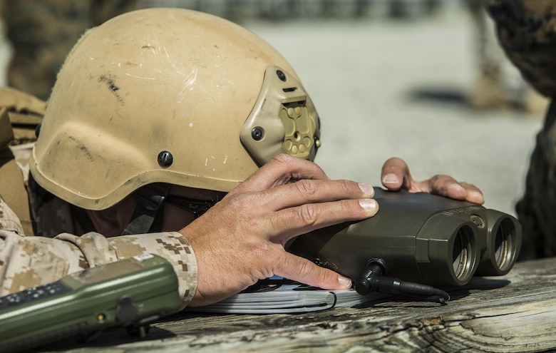 Capt. Richard Bussmann, a joint tactical air controller with 4th Air Naval Gunfire Liaison Company, looks through binoculars as he directs fires during a joint tactical air operation at Camp Lejeune, N.C., March 25, 2016. 4th ANGLICO, a reserve unit, participated in the exercise to enhance interoperability between the U.S., French, British, and Dutch forces, while the U.S. Marines provided fire and aviation support. (U.S. Marine Corps photo by Lance Cpl. Erick Galera/Released)