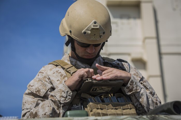 Capt. Richard Bussmann, a joint tactical air controller with 4th Air Naval Gunfire Liaison Company, takes notes as he directs fires during a joint tactical air operation at Camp Lejeune, N.C., March 25, 2016. 4th ANGLICO, a reserve unit, participated in the exercise to enhance interoperability between the U.S., French, British, and Dutch forces, while the U.S. Marines provided fire and aviation support.    (U.S. Marine Corps photo by Lance Cpl. Erick Galera/Released)