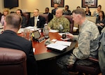 DLA Director Air Force Lt. Gen. Andy Busch (right) listens as staff members brief him on DLA Disposition Services’ Annual Operation Plan.