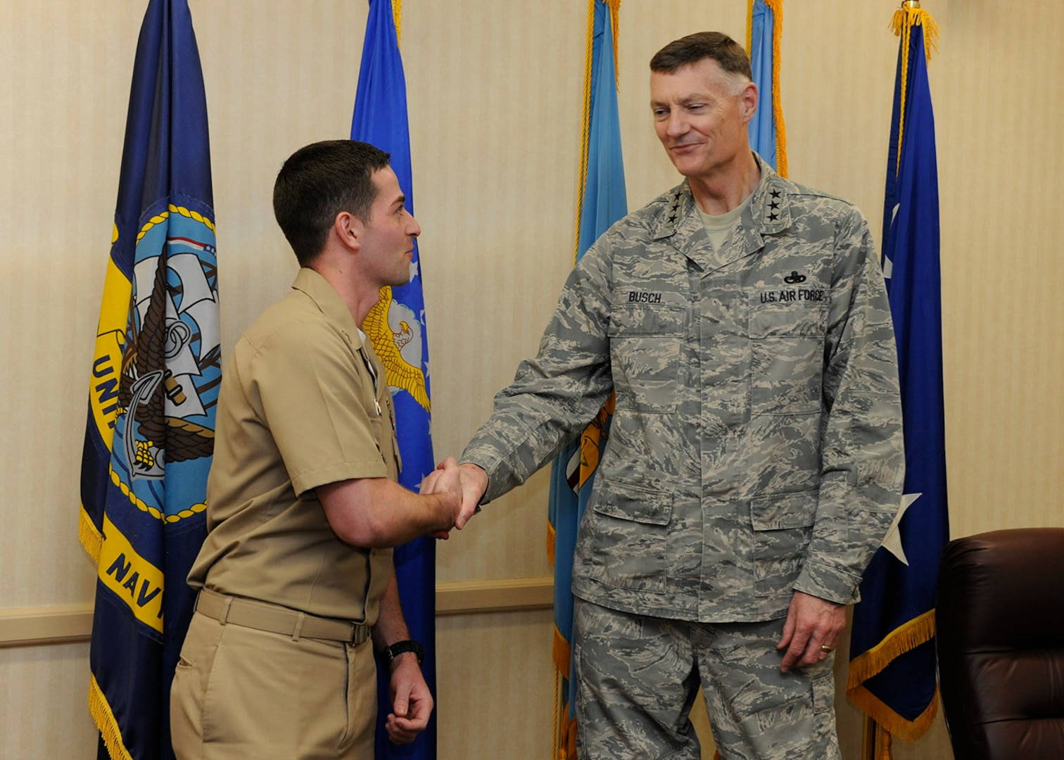 Busch presents a ceremonial coin to Navy Lt. Joseph Thomas for his work supporting expeditionary operations for DLA Disposition Services