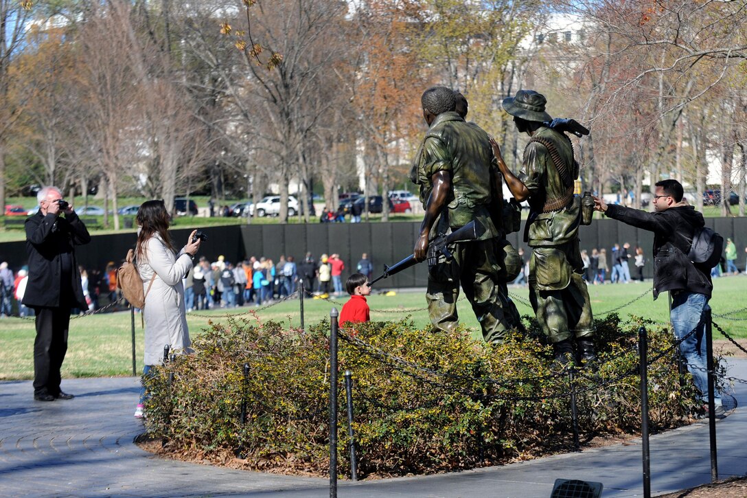Visitors photograph the Three Servicemen statue in Washington, D.C., March 29, 2016. DoD photo by Marvin Lynchard