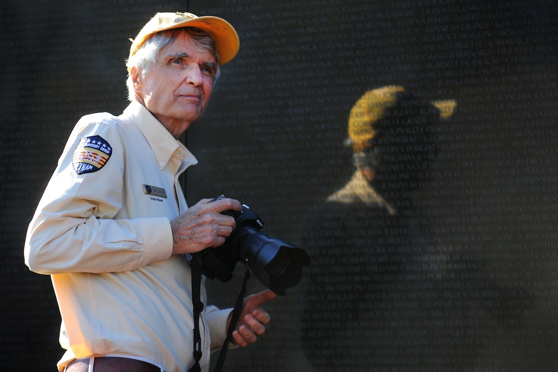Daniel R. Arant, an Annapolis, Md., resident and Vietnam Veterans Memorial volunteer, assists visitors at the memorial in Washington, D.C., March 29, 2016. DoD photo by Marvin Lynchard