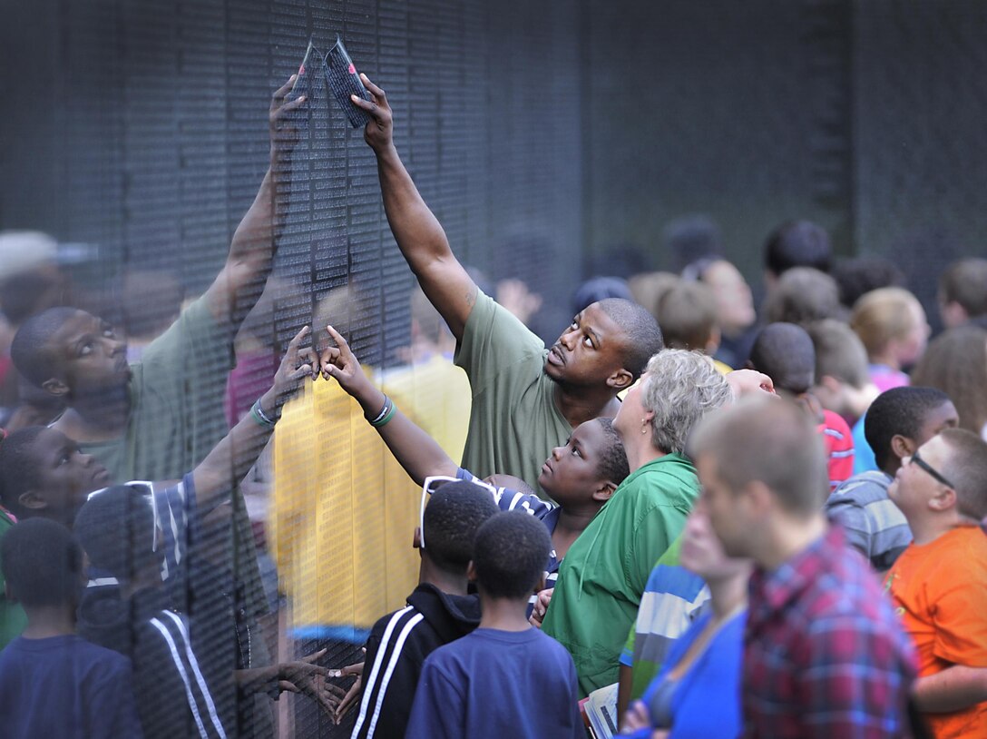 Veterans, service members, military family members and other visitors pay respects to fallen and missing service members from the Vietnam War at the Vietnam Veterans Memorial in Washington, D.C., March 29, 2016. DoD photo by Marvin Lynchard
