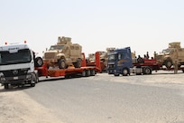 K-Crossing, Kuwait – Iraqi trucks line up as US Soldiers load Caiman MRAPs on their trailers. The delivery of 28 MRAPs to the Iraqi government is part of the US-led Iraqi Security Forces Development and Equipping Program. (US Army photo by Master Sgt. Dave Thompson, 1TSC Public Affairs)