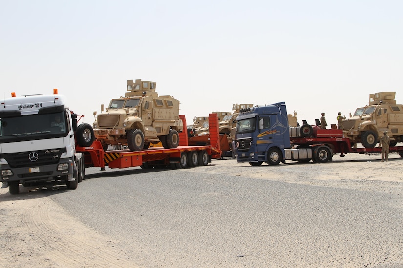 K-Crossing, Kuwait – Iraqi trucks line up as US Soldiers load Caiman MRAPs on their trailers. The delivery of 28 MRAPs to the Iraqi government is part of the US-led Iraqi Security Forces Development and Equipping Program. (US Army photo by Master Sgt. Dave Thompson, 1TSC Public Affairs)