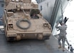 Kuwait Naval Base, Kuwait –A Bradley Fighting Vehicle rolls off the ramp of an Army Logistics Support Vessel during a training exercise.  Army watercraft are designed to operate in austere to bare beach environment and are not dependent upon developed seaports or infrastructure.  1TSC has a vested interest in the operational ability of Army vessels as they are integral to meeting heavy sustainment lift requirements. (US Army photo by Master Sgt. Dave Thompson, 1TSC Public Affairs)