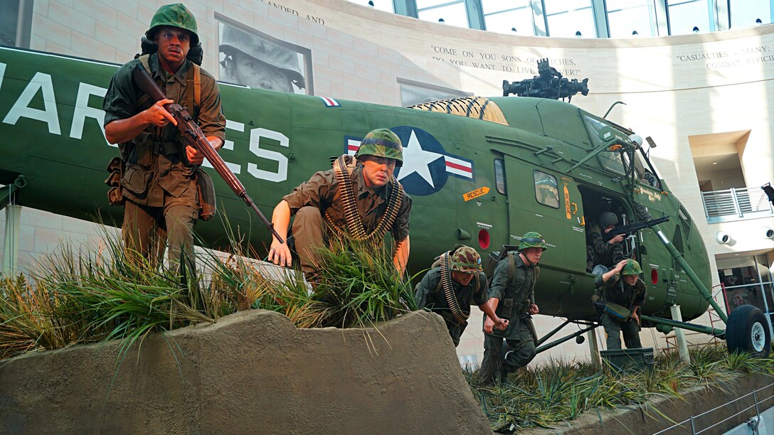 This new tableau depicts Marines heading for cover as they exit a Vietnam-era  Sikorsky UH-34D helicopter during Operation Starlite in 1965.  Active duty Marines and a Corpsman were used as models to create the cast  figures for the new tableau. 
