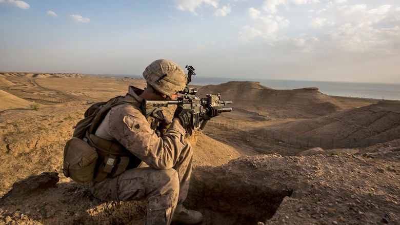 U.S. Marine Sgt. Josh Greathouse, a team leader with Company B, 1st Battalion, 7th Marine Regiment, Special Purpose Marine Air Ground Task Force - Crisis Response - Central Command, scans the area during a perimeter patrol in Al Taqaddum, Iraq, March 21, 2016. SPMAGTF-CR-CC Marines are responsible for the force protection of coalition assets at some Combined Joint Task Force – Operation Inherent Resolve bases within the U.S. Central Command area of responsibility as part of the effort to defeat the Islamic State of Iraq and Levant.