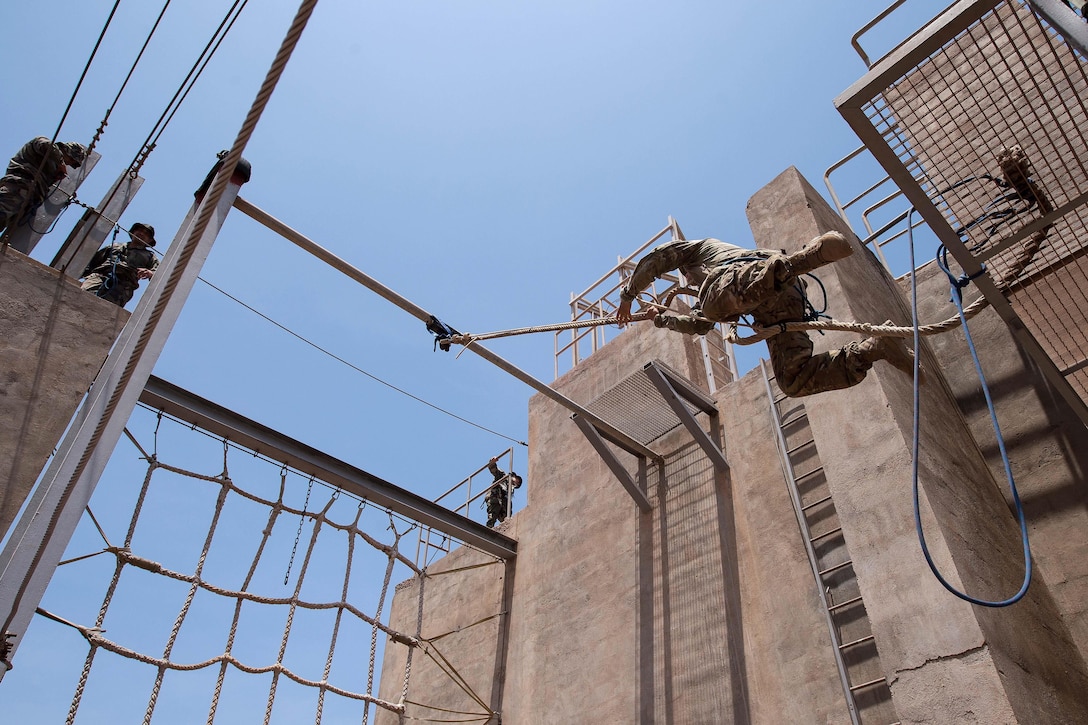 U.S. and French Foreign Legion soldiers negotiate a rope obstacle during a desert commando course in Arta, Djibouti, March 13, 2016. The soldier is assigned to Combined Joint Task Force-Horn of Africa. Air Force photo by Tech. Sgt. Barry Loo