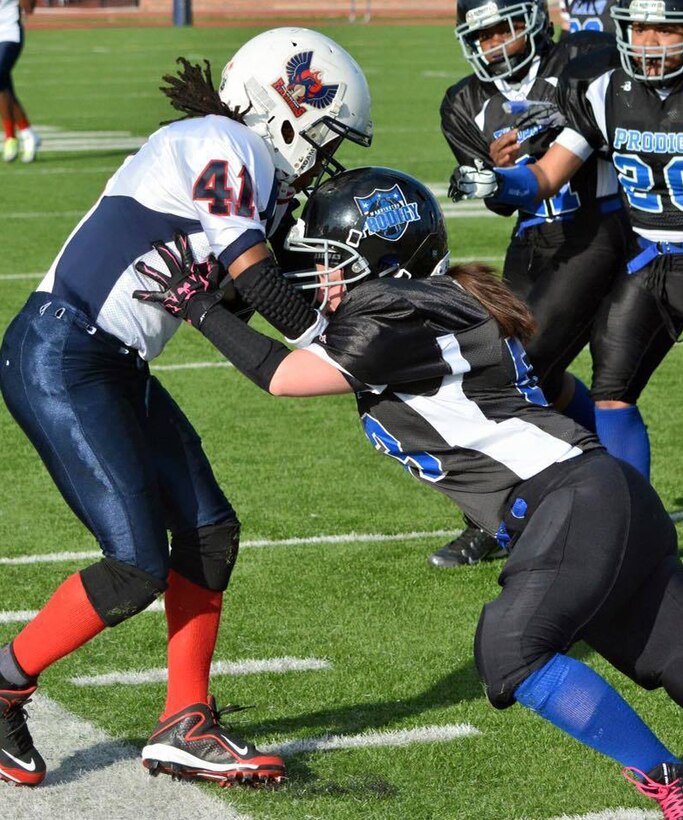 Navy Petty Officer 1st Class Colleen Dibble makes a tackle during a Washington Prodigy Women’s Football game, May 9, 2015.
