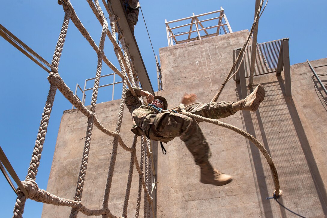A U.S. soldier negotiates a rope obstacle during a desert commando course in Arta, Djibouti, March 15, 2016. Air Force photo by Tech. Sgt. Barry Loo