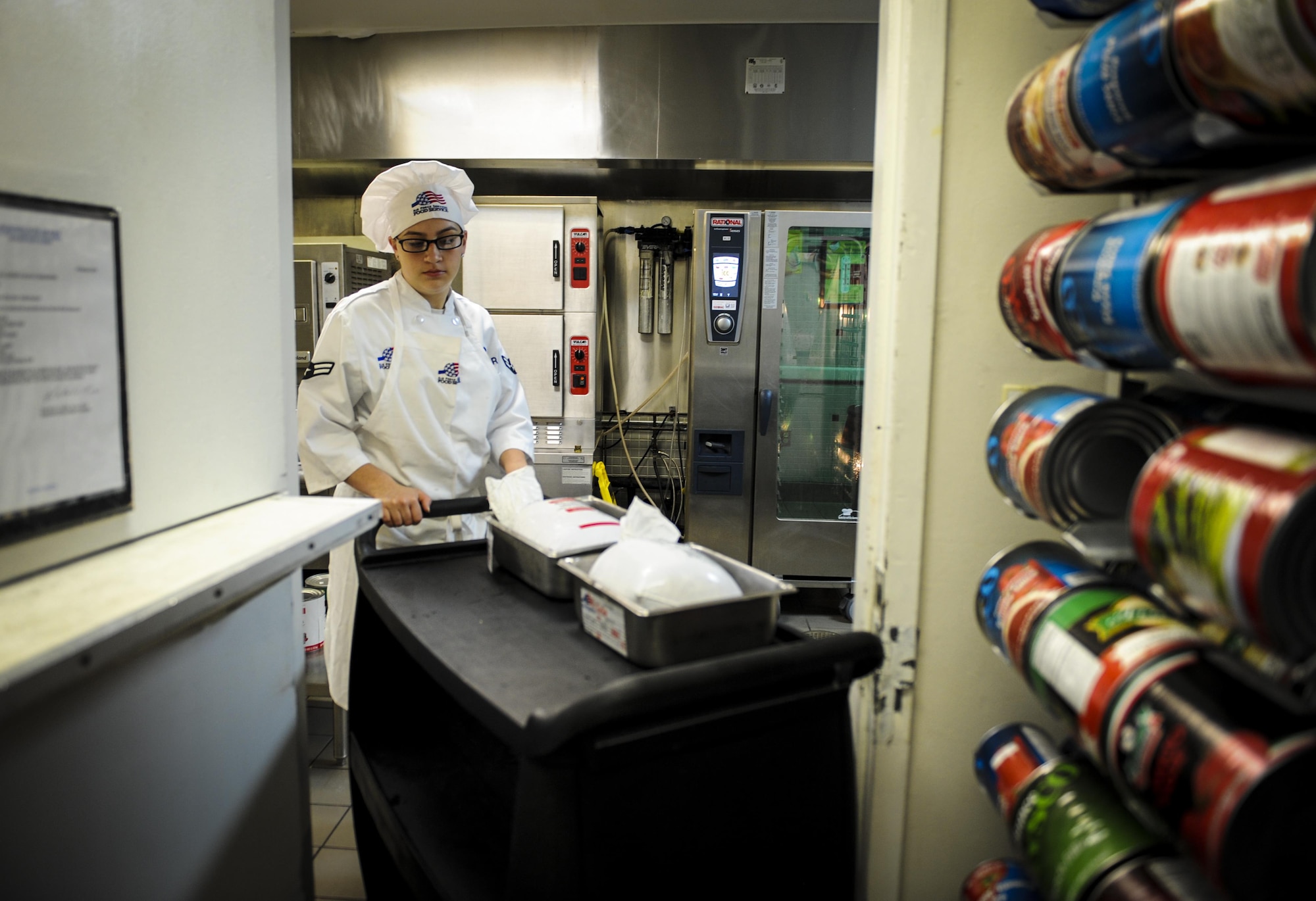 Airman 1st Class Tyler Aguilar, a food service journeyman with the 1st Special Operations Force Support Squadron, transfers turkey from storage to be prepared for cooking at The Reef, Hurlburt Field, Fla., March 28, 2016. Aguilar is The Reef dining facility’s food preparation cook, in charge of preparing the meat and bread served. (U.S. Air Force photo by Senior Airman Meagan Schutter)