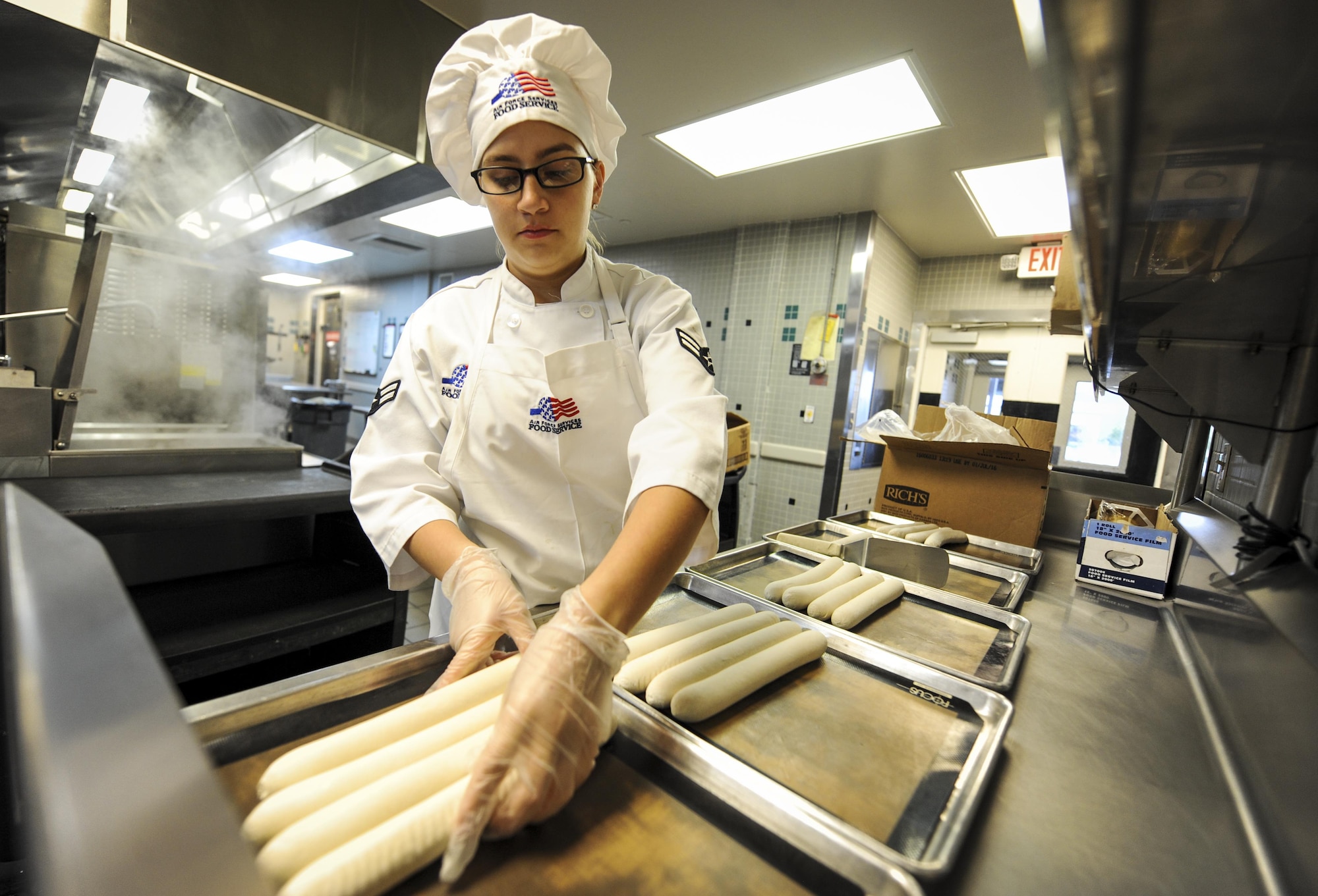 Airman 1st Class Tyler Aguilar, a food service journeyman with the 1st Special Operations Force Support Squadron, prepares bread to be baked at The Reef, Hurlburt Field, Fla., March 28, 2016. Aguilar is The Reef dining facility’s food preparation cook, in charge of preparing the meat and bread served. (U.S. Air Force photo by Senior Airman Meagan Schutter)