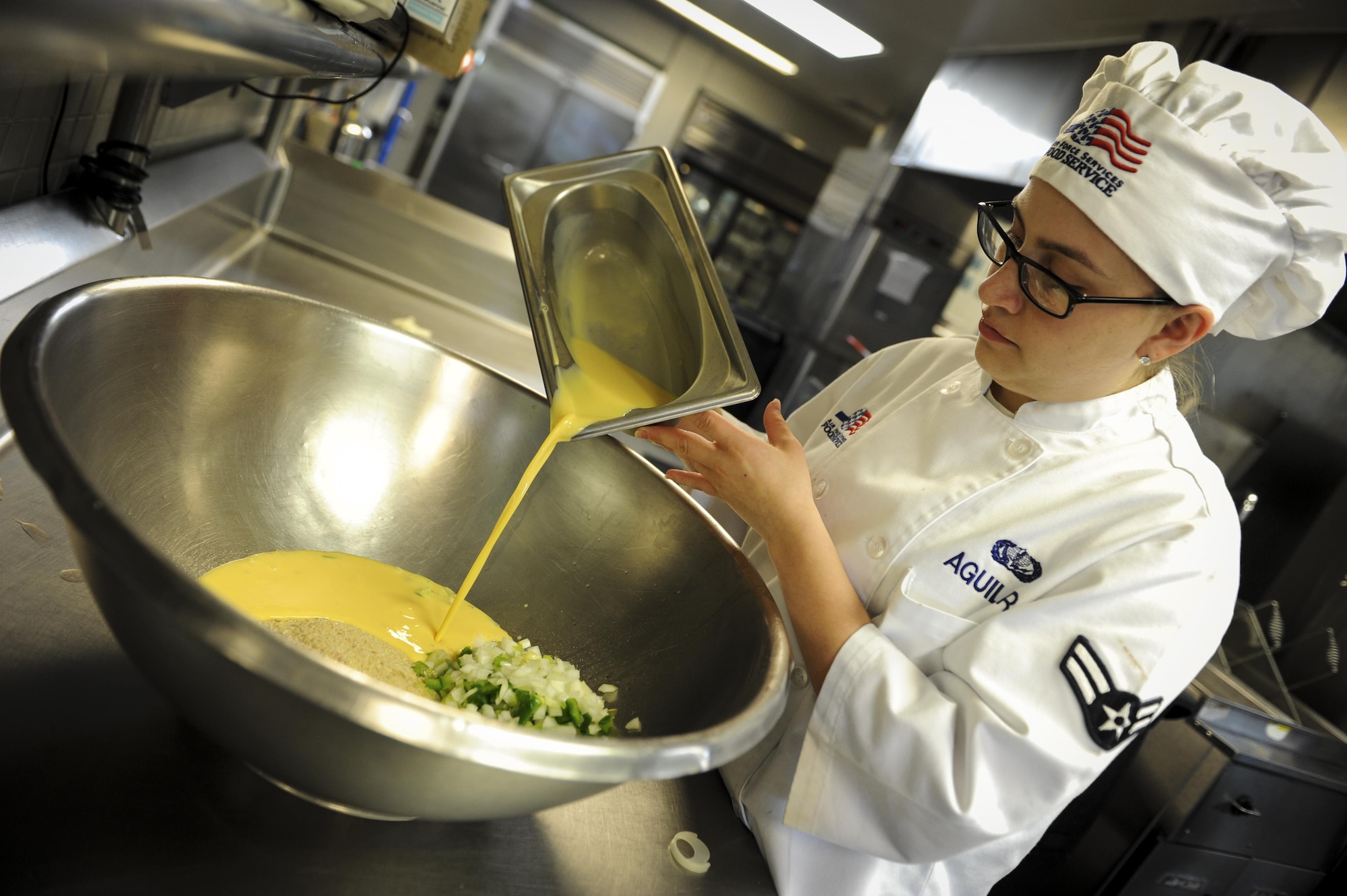 Airman 1st Class Tyler Aguilar, a food service journeyman with the 1st Special Operations Force Support Squadron, adds egg to a meatloaf mixture at the Reef, Hurlburt Field, Fla., March 28, 2016. Aguilar is The Reef dining facility’s food preparation cook, in charge of preparing the meat and bread served. (U.S. Air Force photo by Senior Airman Meagan Schutter)
