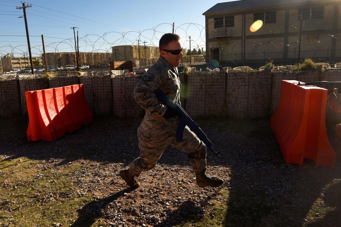 Air Force Staff Sgt. Andrew Ness practices tactical movement and response to fire procedures during Operational Contract Support Joint Exercise 2016 at Fort Bliss, Texas, March 24, 2016. Air Force photo by Staff Sgt. Jonathan Snyder 