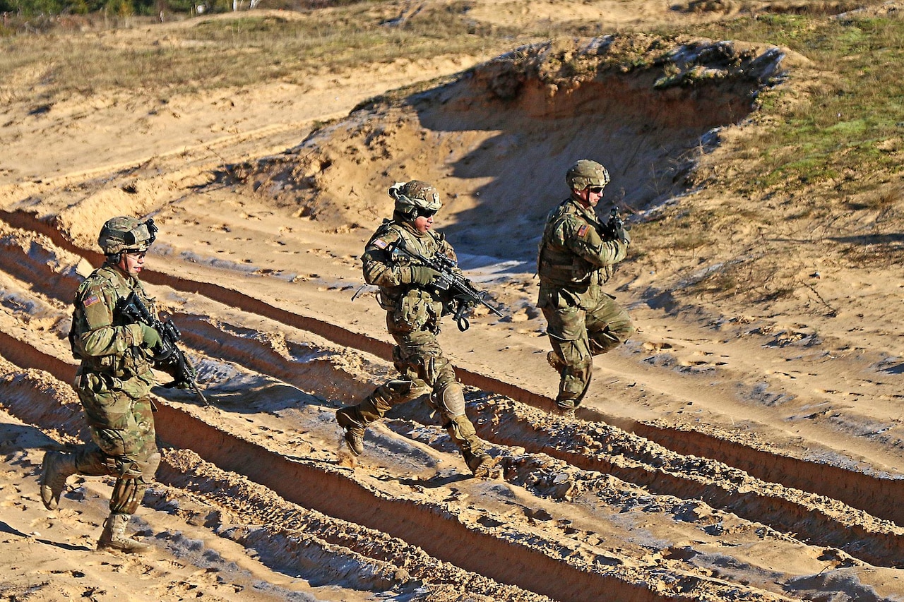 Army Spc. Devon Rivera, left, Army Sgt. Jorge Martinez and Army Pfc. Justin Giaimo, right, all indirect-fire infantrymen assigned to Headquarters and Headquarters Troop, 3rd Squadron, 2nd Cavalry Regiment, bound to a fighting position while rehearsing before a multinational mortar live fire exercise alongside Latvian partners at Adazi Military Base, Latvia, Feb. 17, 2016. As part of the U.S. commitment to increased assurance and deterrence, U.S. Army Europe will begin receiving continuous troop rotations of U.S.-based armored brigade combat teams to the European theater in early 2017, bringing the total Army presence in Europe up to three fully-manned Army brigades. U.S. Army photo by Sgt. Paige Behringer