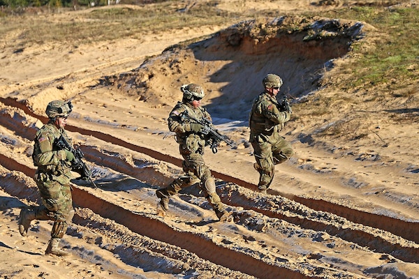 Army Spc. Devon Rivera, left, Army Sgt. Jorge Martinez and Army Pfc. Justin Giaimo, right, all indirect-fire infantrymen assigned to Headquarters and Headquarters Troop, 3rd Squadron, 2nd Cavalry Regiment, bound to a fighting position while rehearsing before a multinational mortar live fire exercise alongside Latvian partners at Adazi Military Base, Latvia, Feb. 17, 2016. As part of the U.S. commitment to increased assurance and deterrence, U.S. Army Europe will begin receiving continuous troop rotations of U.S.-based armored brigade combat teams to the European theater in early 2017, bringing the total Army presence in Europe up to three fully-manned Army brigades. U.S. Army photo by Sgt. Paige Behringer