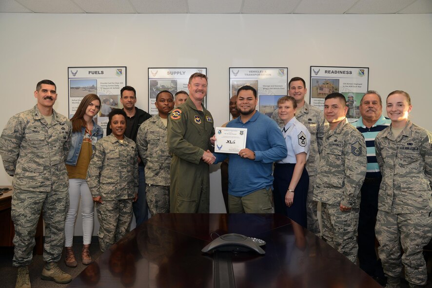 Salvador Pascacio, center, 47th Logistics Readiness Flight resource advisor, accepts the “XLer of the Week” award from Col. Thomas Shank, left, 47th Flying Training Wing commander, and Chief Master Sgt. Teresa Clapper, right, 47th FTW command chief, here, March 24, 2016. The XLer is a weekly award chosen by wing leadership and is presented to those who consistently make outstanding contributions to their unit and Laughlin. (U.S. Air Force photo by Airman 1st Class Brandon May)