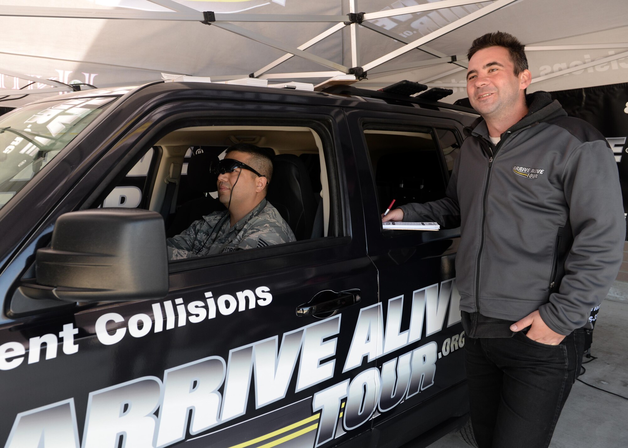 Staff Sgt. Ngoc-Lan (left), 548th Operation Support Squadron GEOINT program manager, operates a virtual simulated vehicle, which emulated being under the influence of alcohol during a demonstration from the Arrive Alive Tour March 29, 2016, at Beale Air Force Base, California. The Arrive Alive Tour provided a demonstration, which gave Airmen the opportunity to experience the realistic effects of driving under the influence, and texting while operating a vehicle.  (U.S. Air Force photo by Senior Airman Ramon A. Adelan)