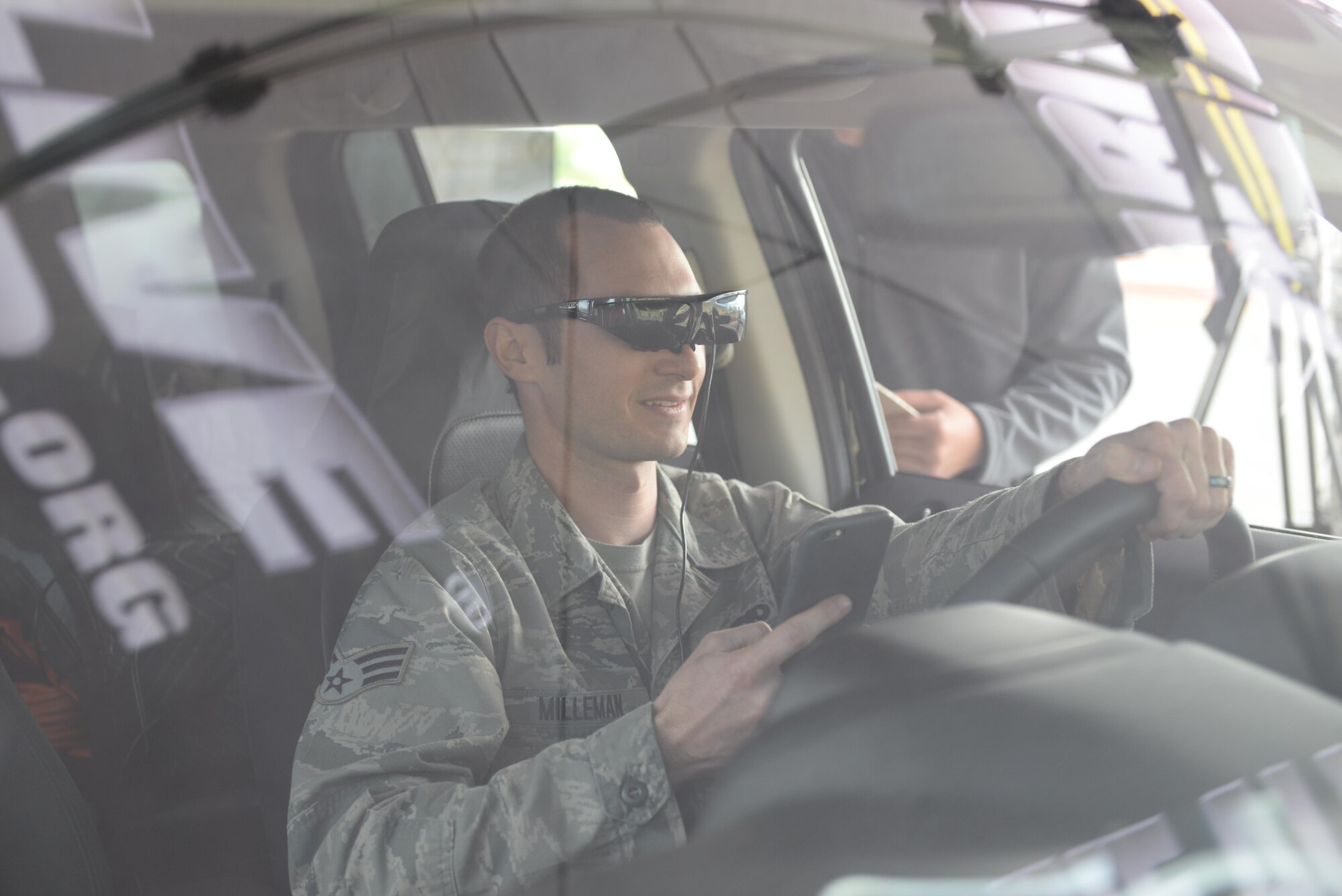 Senior Airman Ryan Milleman, 9th Aircraft Maintenance Squadron crew chief, operates a virtually simulated vehicle while he tries to text during a demonstration from the Arrive Alive Tour March 28, 2016, at Beale Air Force Base, California. The Arrive Alive Tour provided a demonstration, which gave Airmen the opportunity to experience the realistic effects of driving under the influence, and texting while operating a vehicle. (U.S. Air Force photo by Senior Airman Ramon A. Adelan)