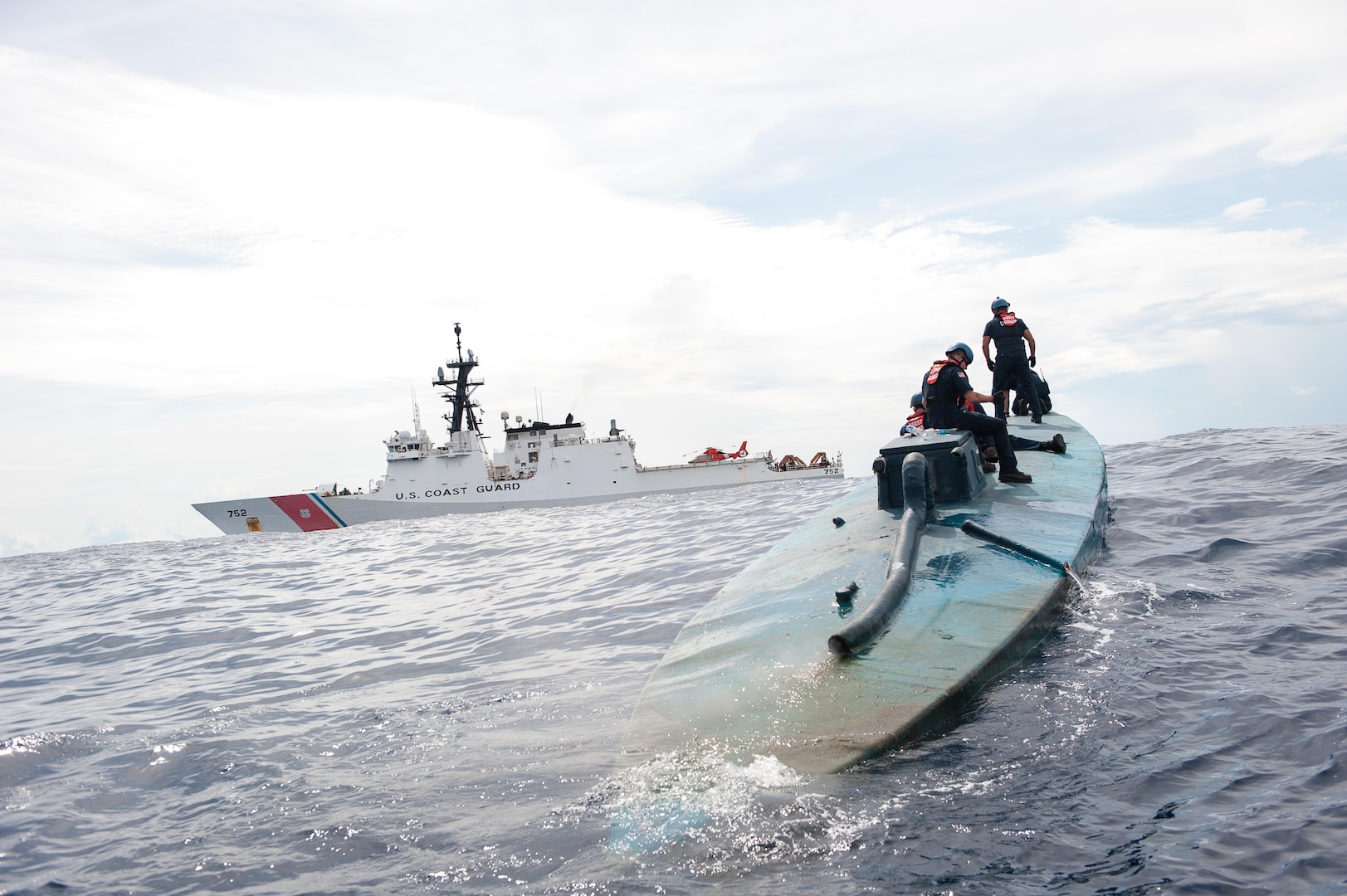 A Coast Guard Cutter Stratton boarding team investigates a self-propelled semi-submersible interdicted in international waters off the coast of Central America, July 19, 2015. The Stratton’s crew recovered more than 6 tons of cocaine from the 40-foot vessel. Coast Guard photo by Petty Officer 2nd Class LaNola Stone