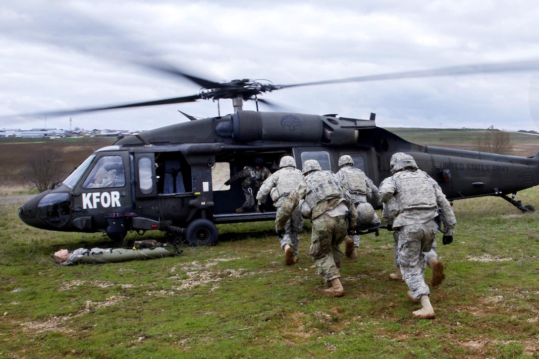 Soldiers load a simulated casualty into a UH-60 Black Hawk helicopter during medevac training at Camp Bondsteel, Kosovo, March 15, 2016. The soldiers, assigned to the 4th Infantry Division’s 1st Battalion, 41st Infantry Regiment, 2nd Infantry Brigade Combat Team, are deployed from Fort Carson, Colo. Army photo by Staff Sgt. Thomas Duval 