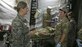 Staff Sgt. Anastasia Stuart, left, assigned to the 6th Medical Support Squadron, translates instructions about the medical equipment in Zhytomyr, Ukraine, Aug. 18, 2015. Stuart was selected by the Language Enabled Airman Program to interpret and translate between U.S Air Force Airmen and Ukrainian soldiers. (Courtesy photo) 