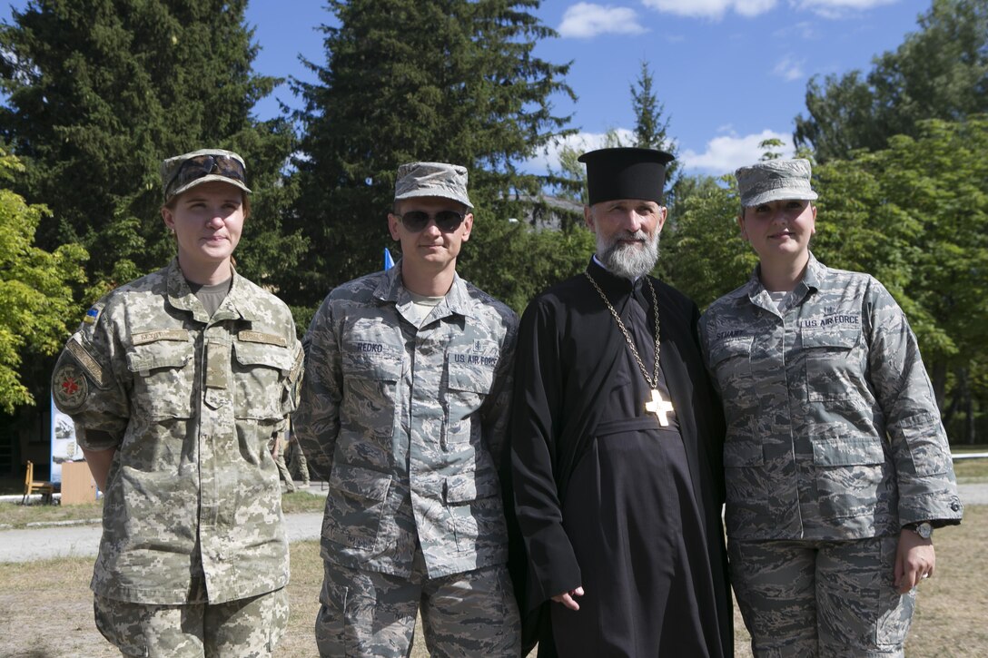 Staff Sgt. Anastasia Stuart, right, assigned to the 6th Medical Support Squadron, poses for a photo with attendees of the Expeditionary Medical Support System training in Zhytomyr, Ukraine, Aug. 18, 2015. Stuart was selected by the Language Enabled Airman Program to interpret and translate between U.S Air Force Airmen and Ukrainian soldiers. (Courtesy photo) 