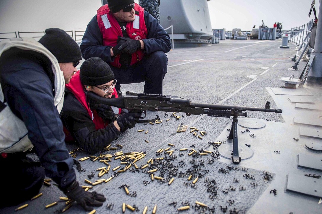 Petty Officer 3rd Class Pedro Villareal fires an M-240B light machine gun during a weapons shoot aboard the USS Mobile Bay in the waters surrounding the Korean Peninsula, March 26, 2016. The Mobile Bay is on a regularly scheduled U.S. 7th Fleet deployment. Navy photo by Petty Officer 2nd Class Ryan J. Batchelder