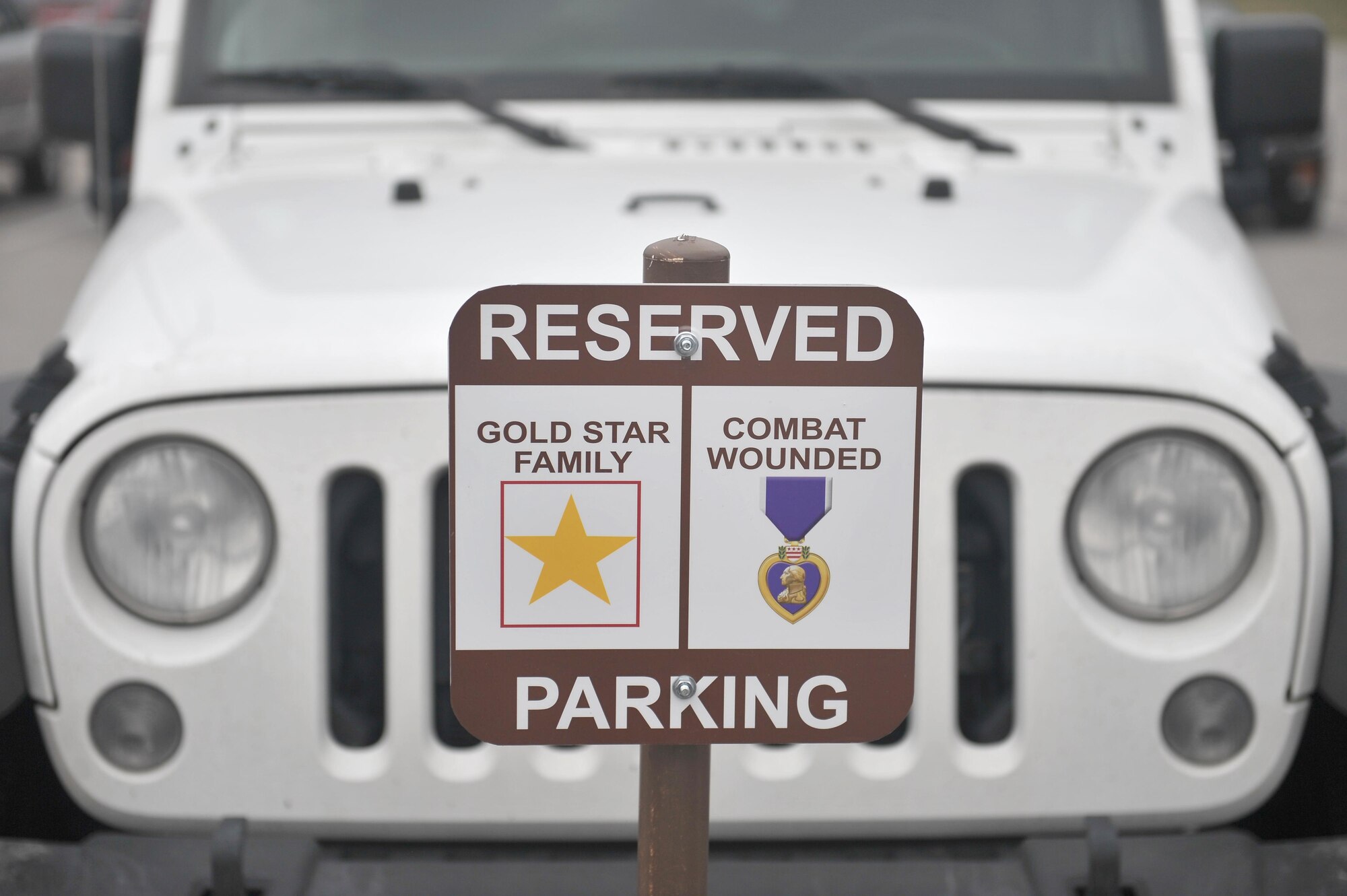 New signs have been posted on base to reserve parking spots for Combat Wounded Veterans and Gold Star Families. The reserved-parking signs were put up at the Commissary, Exchange, Offutt Field House and the Patriot Club. (U.S. Air Force photo by Zachary Hada)