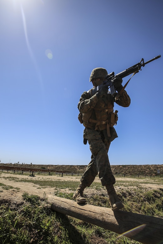 Private Michael L. Riddle, Delta Company, 1st Recruit Training Battalion, runs over an obstacle during a Crucible event at Marine Corps Base Camp Pendleton, March 23. Riddle is graduating as a squad leader and plans on staying in the Marine Corps for as long as possible. Following graduation, he will continue his training at the School of Infantry at MCB CPEN, to learn his primary job as an infantryman.  Riddle intends to finish his degree and eventually become a counter terrorist agent. Annually, more than 17,000 males recruited from the Western Recruiting Region are trained at MCRD San Diego. Delta Company is scheduled to graduate April 1.