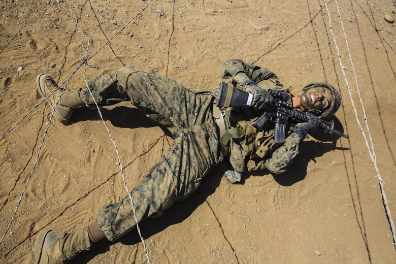 Private Michael L. Riddle, Delta Company, 1st Recruit Training Battalion, craws under concertina wire during a Crucible event at Marine Corps Base Camp Pendleton, March 23. Riddle is graduating as a squad leader and plans on staying in the Marine Corps for as long as possible. Following graduation, he will continue his training at the School of Infantry at MCB CPEN, to learn his primary job as an infantryman.  Riddle intends to finish his degree and eventually become a counter terrorist agent. Annually, more than 17,000 males recruited from the Western Recruiting Region are trained at MCRD San Diego. Delta Company is scheduled to graduate April 1.