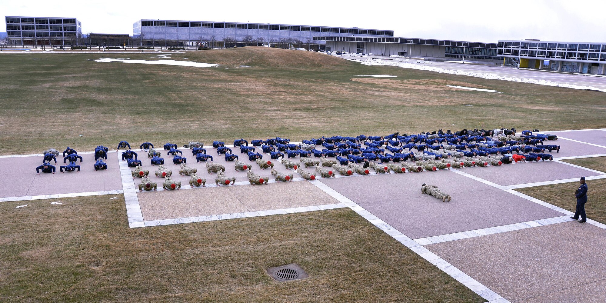 Cadets at the U.S. Air Force Academy join Air Force special operators in a series of pushups to honor Capt. Matthew Roland, 27, a 2010 Academy graduate and Air Force special operator who died Aug. 26, 2015 near Camp Antonik, Afghanistan. Roland was a special tactics officer at the 23rd Special Tactics Squadron, Hurlburt Field, Fla. (U.S. Air Force photo/Jason Gutierrez))