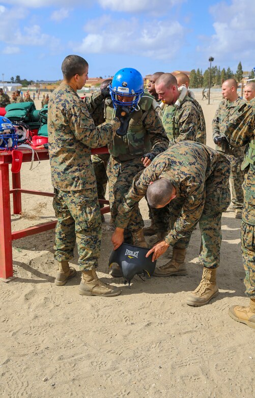 Recruits of Alpha Company, 1st Recruit Training Battalion, help prepare a recruit for his fight during Pugil Sticks III at Marine Corps Recruit Depot San Diego, March 29. Recruits were given protective gear which included a helmet, groin protector, flak jacket and a pugil stick that simulated a rifle. Annually, more than 17,000 males recruited from the Western Recruiting Region are trained at MCRD San Diego. Alpha Company is scheduled to graduate April 22.