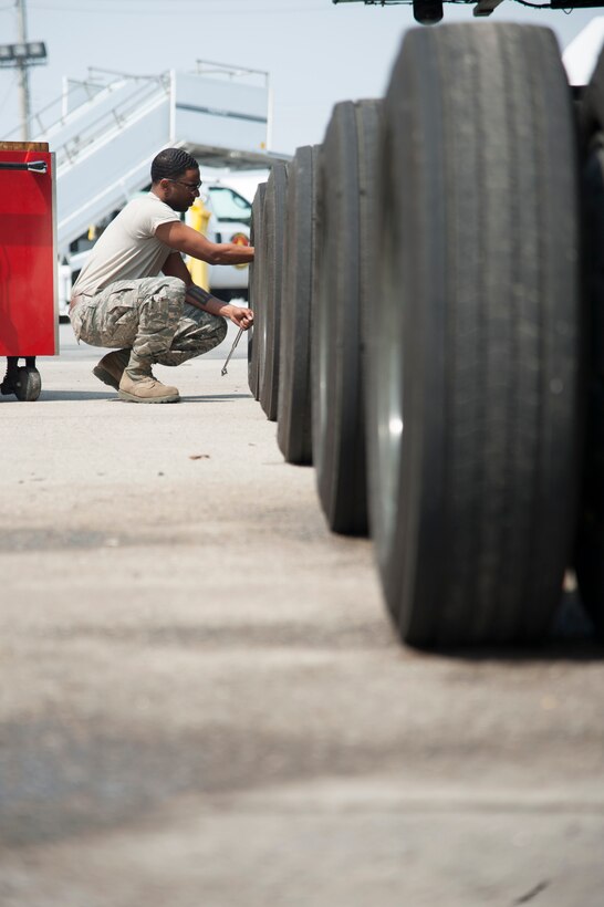 Staff Sgt. Sergio McLaughlin, 51st Logistics Readiness Squadron sorting generating and aircraft sustaining vehicle maintainer, checks tire pressure on a Tunner 60k loader at Osan Air Base, Republic of Korea, March 30, 2016. McLaughlin conducted a limited technical inspection that consisted of mechanical, electrical and hydraulic function checks. (U.S. Air Force photo by Staff Sgt. Jonathan Steffen/Released)