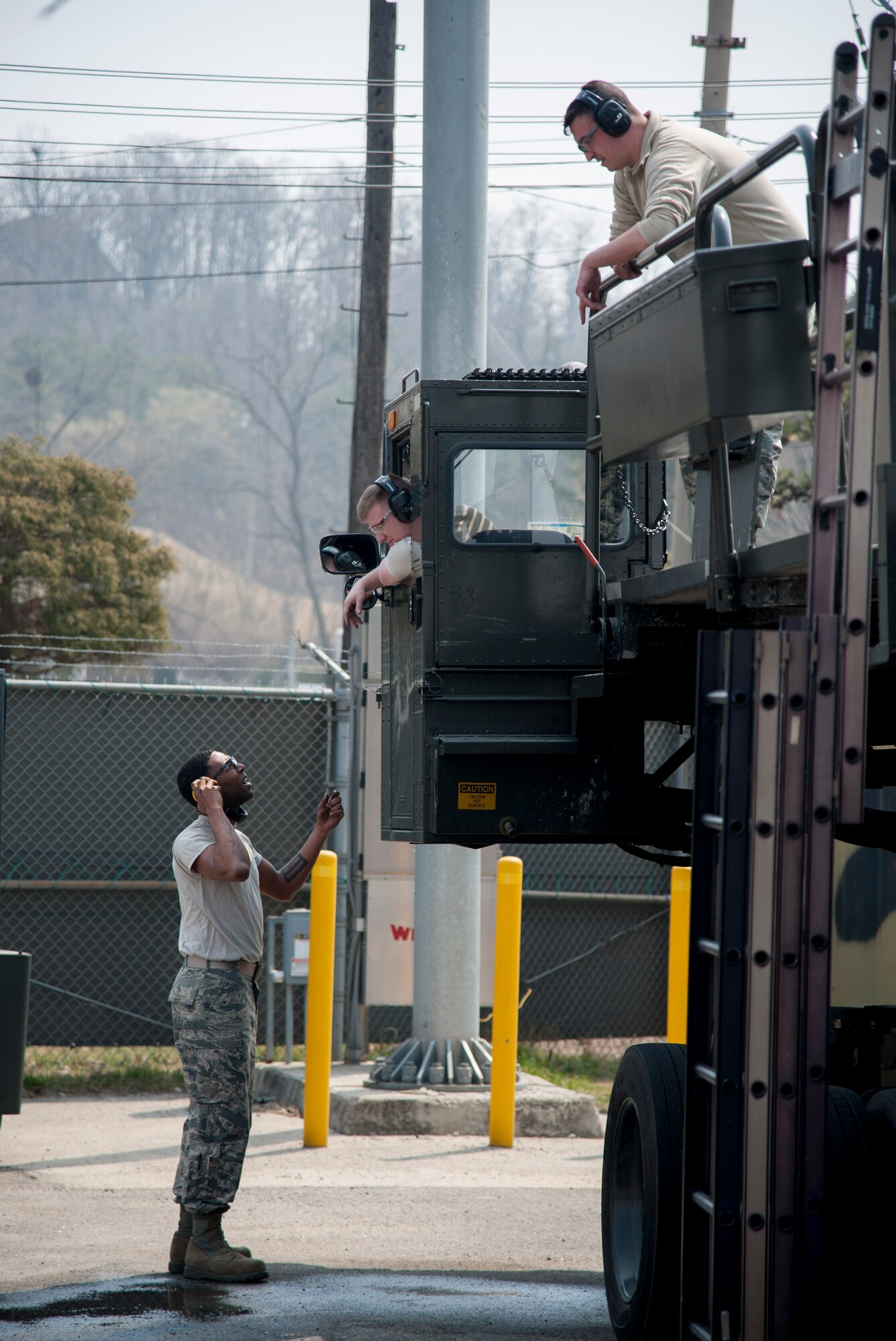Staff Sgt. Sergio McLaughlin, Senior Airman Zachery White and Senior Airman Jonathan Rowley, 51st Logistics Readiness Squadron sorting generating and aircraft sustaining vehicle maintainers, discuss limited technical inspection plans for a Tunner 60K loader at Osan Air Base, Republic of Korea, March 30, 2016. The maintainers performed inspections on mechanical, electrical and hydraulic systems prior to returning the vehicle to flight line. (U.S. Air Force photo by Staff Sgt. Jonathan Steffen/Released)