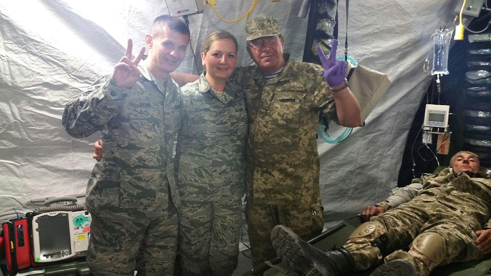 Staff Sgt. Anastasia Stuart, assigned to the 6th Medical Support Squadron (middle), pauses for a photo with attendees of the Expeditionary Medical Support System training in Zhytomyr, Ukraine, August 2015. Stuart was in Ukraine for five weeks. (Courtesy photo) 