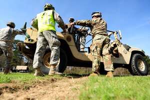 U.S. Soldiers assigned to the 7th Transportation Brigade and the 689th Rapid Port Opening Element prepare to conduct sling-load operations at Fort Eustis, Va., March 24, 2016. Sling-loading involves rigging large equipment to cargo-aircraft when roadways are unavailable. (U.S. Air Force photo by Staff Sgt. Natasha Stannard)