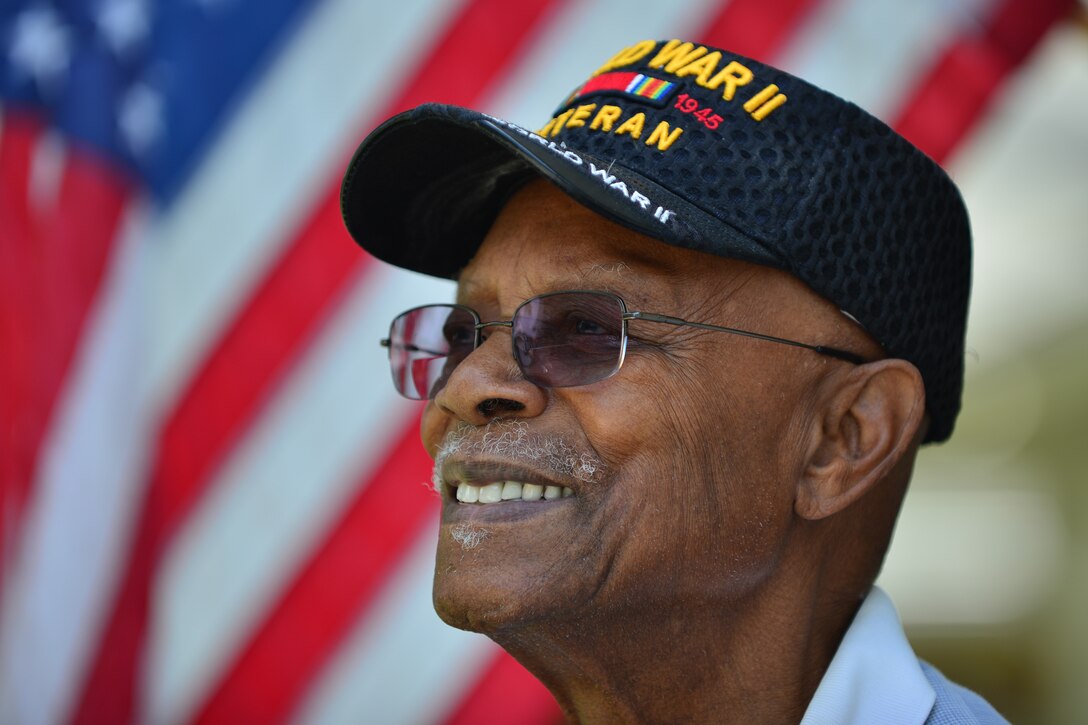 Retired U.S. Army Col. Aaron M. Dotson, a World War II and Vietnam War veteran, reflects on his military career outside of his home in Hampton, Va., Aug. 8, 2015. Dotson was drafted as a cargo checker during World War II and later commissioned as a social work officer. (U.S. Air Force photo by Staff Sgt. Natasha Stannard)