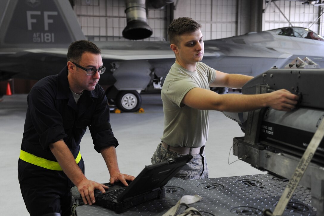 U.S. Air Force Tech. Sgt. Brian Wagner, a weapons expediter assigned to the 27th Aircraft Maintenance Unit, and Airman 1st Class Jack O’Brien, a weapons load crew member assigned to the 27th Aircraft Maintenance Unit, prepare munitions on a preloaded BRU-61 small bomb carriage system during a training evaluation Langley Air Force Base, Va., March 23, 2016. Weapons crews must meet a specific time standard during loading and unloading operations to be considered proficient.  (U.S. Air Force photo by Senior Airman Brittany E. N. Murphy)
