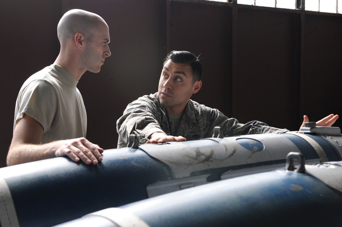 U.S. Air Force Staff Sgt. Kelvin Castillo, a squadron lead crew team chief assigned to the 1st Maintenance Group, discusses weapon specifics and theory of operations for the GBU-32 small diameter bomb with Staff Sgt. Daniel Schriever, a weapons load crew team chief assigned to the 94th Aircraft Maintenance Unit, at Langley Air Force Base, Va., March 23, 2016. The weapons crew training program is evaluated often to ensure its execution during daily flying operations. (U.S. Air Force photo by Senior Airman Brittany E. N. Murphy)