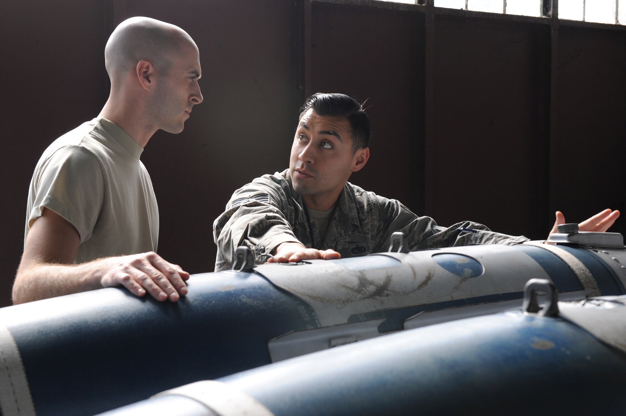 U.S. Air Force Staff Sgt. Kelvin Castillo, a squadron lead crew team chief assigned to the 1st Maintenance Group, discusses weapon specifics and theory of operations for the GBU-32 small diameter bomb with Staff Sgt. Daniel Schriever, a weapons load crew team chief assigned to the 94th Aircraft Maintenance Unit, at Langley Air Force Base, Va., March 23, 2016. The weapons crew training program is evaluated often to ensure its execution during daily flying operations. (U.S. Air Force photo by Senior Airman Brittany E. N. Murphy)
