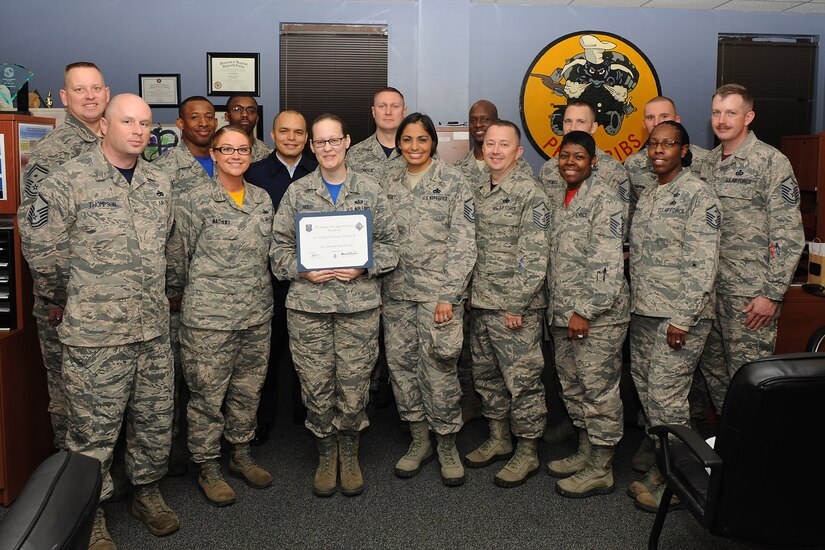 U.S. Air Force first sergeants commend Staff Sgt. Cassandra Hout, a mortuary affairs technician assigned to the 633rd Force Support Squadron, for receiving a Diamond Sharp award at Langley Air Force Base, Va., March 25, 2016. Diamond Sharp awards provide an opportunity for first sergeants to recognize Airmen who excel in all areas of performance and appearance.  (U.S. Air Force photo by Senior Airman Brittany E. N. Murphy)