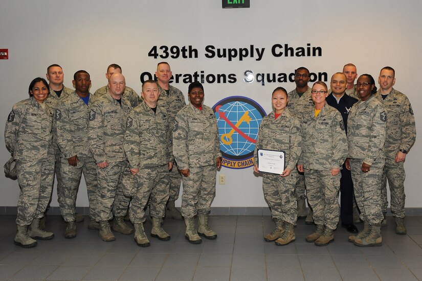 U.S. Air Force first sergeants congratulate Senior Airman Risa Stewart, a command and support staff administrator assigned to the 439th Supply Chain Operations Squadron, for receiving a Diamond Sharp award at Langley Air Force Base, Va., March 25, 2016. Stewart was presented the award for excelling at taking over CSS operations during an office transition, a process not within her typical daily duties. (U.S. Air Force photo by Senior Airman Brittany E. N. Murphy)