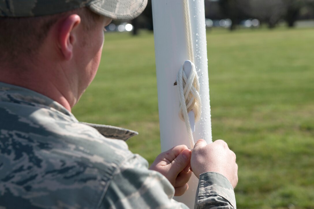 U.S. Air Force Staff Sgt. Steven Spear, a structural craftsman assigned to the 633rd Civil Engineer Squadron, secures a flag pole rope at Memorial Park at Langley Air Force Base, Va., March 25, 2016. The reconstruction of Memorial Park lasted approximately three weeks. (U.S. Air Force photo by Airman 1st Class Derek Seifert) 