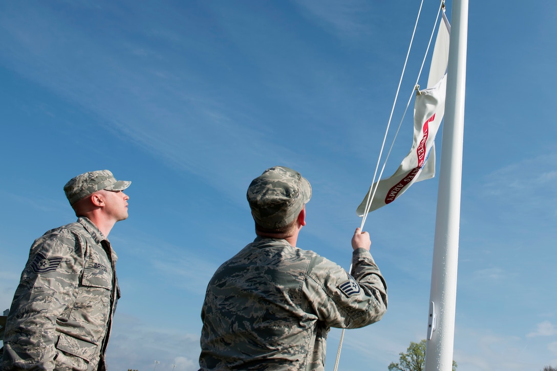 U.S. Air Force Tech. Sgt. Brandon Bridges and Staff Sgt. Steven Spear, structural craftsmen assigned to the 633rd Civil Engineer Squadron, raise a U.S. Army flag at Memorial Park at Langley Air Force Base, Va., March 25, 2016. Flags for the six U.S. territories, the Air Force and Army flags were added during the reconstruction of the park’s flag posts. (U.S. Air Force photo by Airman 1st Class Derek Seifert)