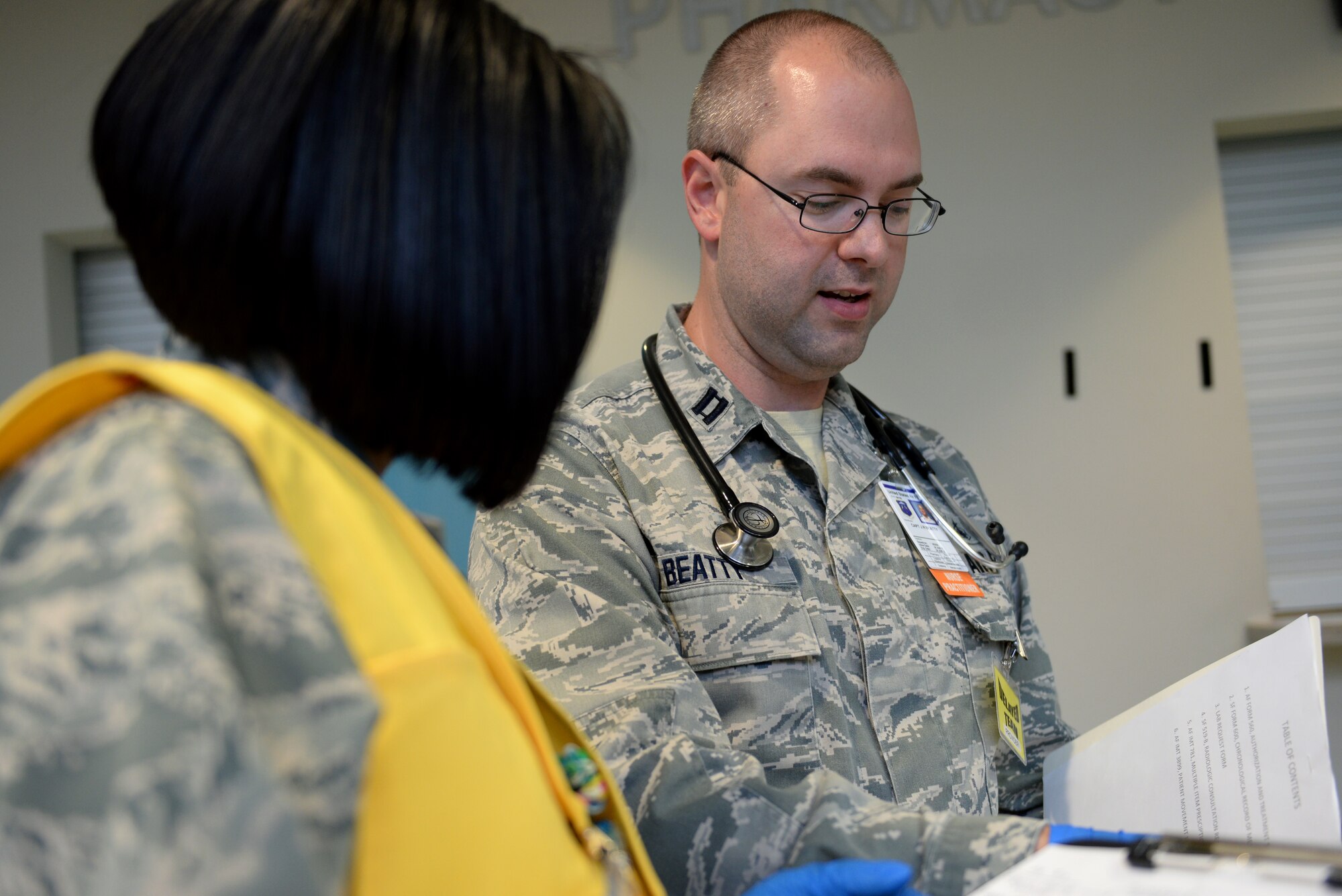 U.S. Air Force Capt. Jonathan Beatty, a family nurse practitioner assigned to the 633rd Medical Group, consults with 2nd Lt. Karenia Borges, a clinical nurse assigned to the 633rd MDG, during amass casualty exercise at Langley Air Force Base, Va., March 24, 2016. The exercise lasted five hours, guaranteeing the medical staff involved was adequately prepared to handle a mass casualty situation. (U.S. Air Force photo by Airman 1st Class Kaylee Dubois)