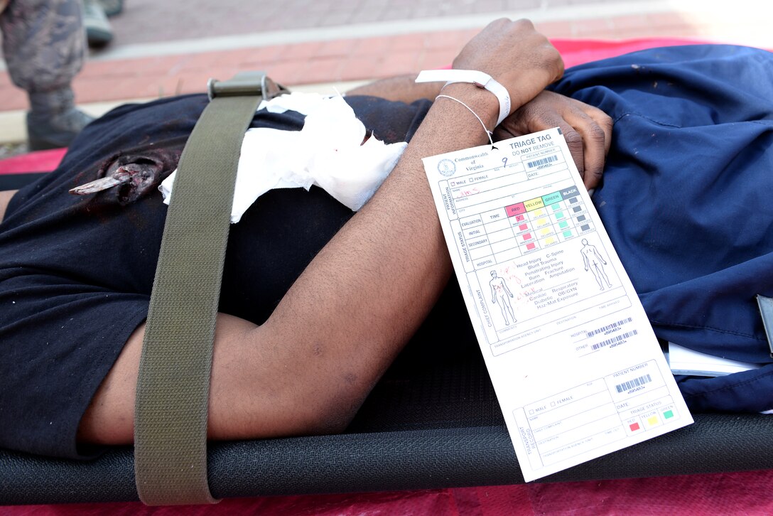 A casualty lays awaiting transport during a mass casualty exercise at Langley Air Force Base, Va., March 24, 2016. The medical staff practiced providing care for 30 patients with simulated realistic injuries during the exercise to gain experience with mass casualty events.  (U.S. Air Force photo by Airman 1st Class Kaylee Dubois)